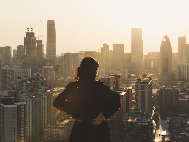 silhouette of woman looking at city landscape